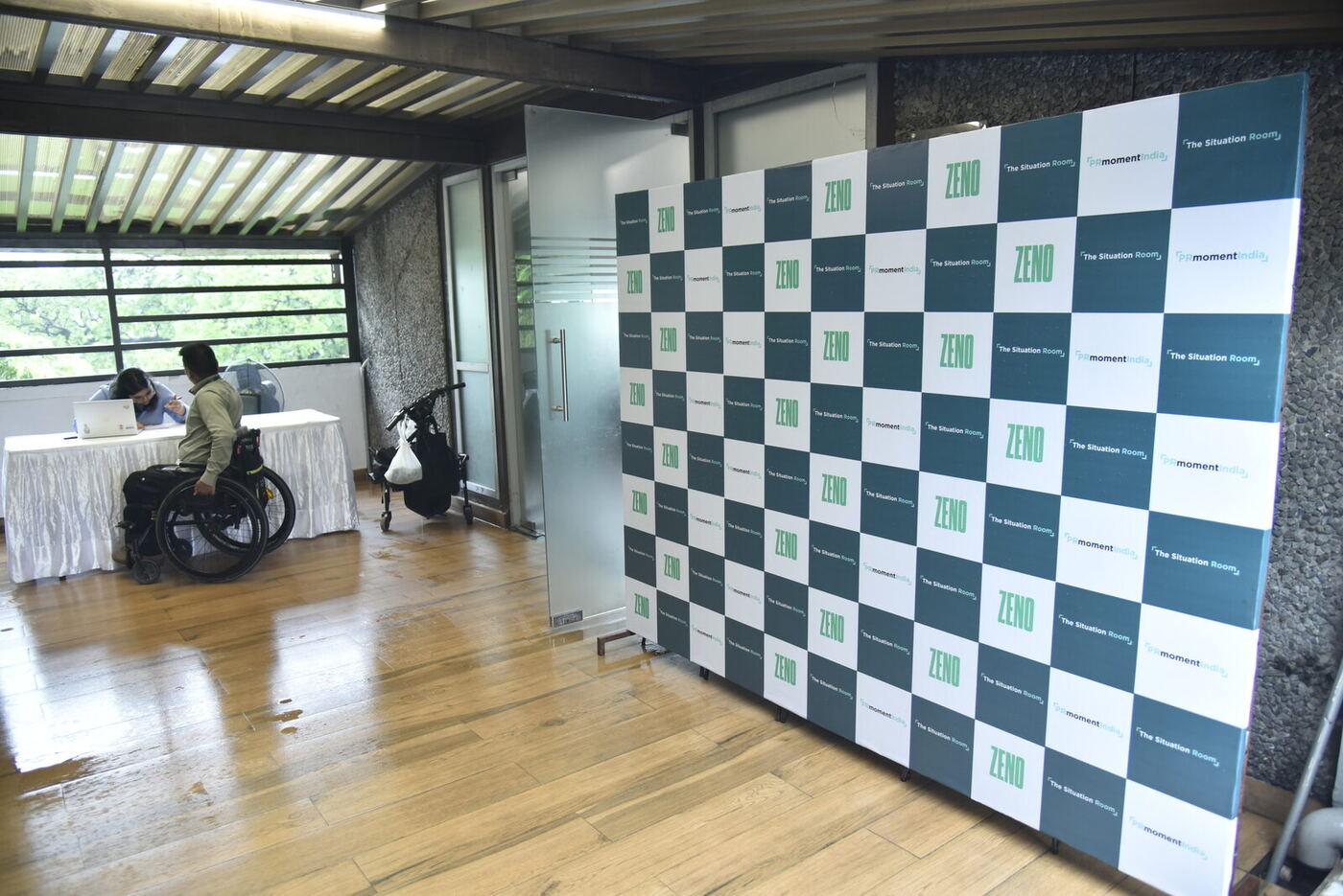 ZENO / PRmoment India step-and-repeat on the veranda with the registration table alongside