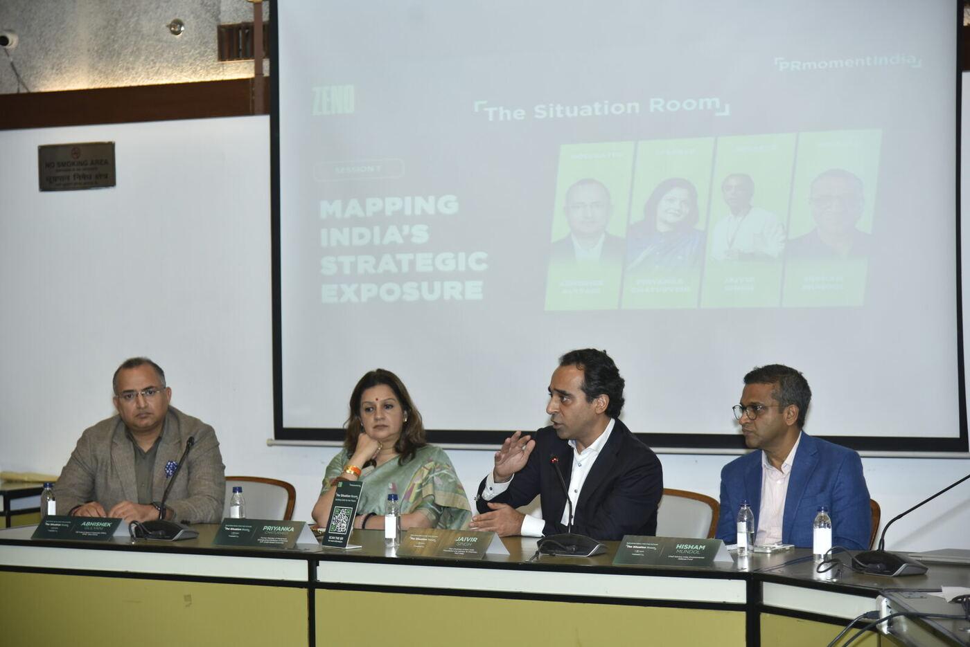 Jaivir Singh mid-gesture answering, Priyanka listening chin on hand, full session slide behind